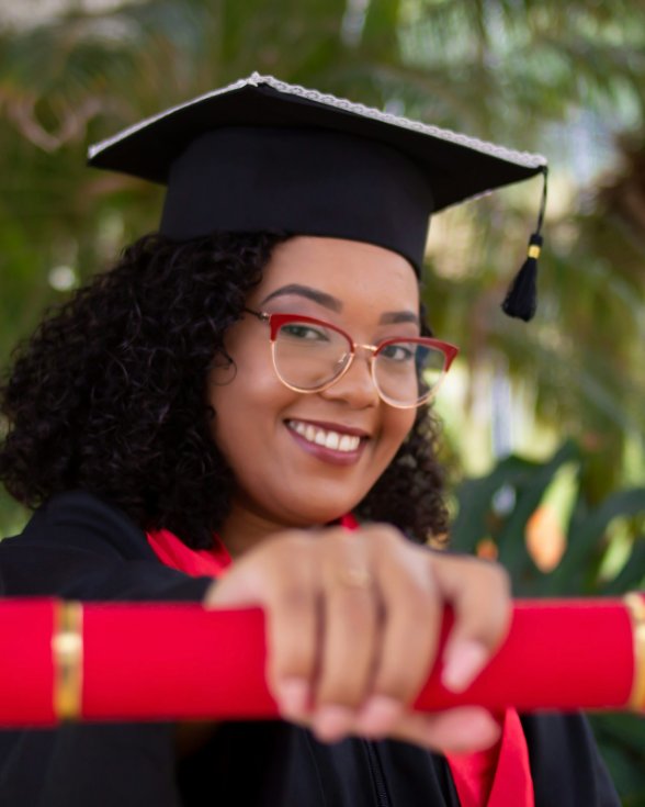 Smiling graduate holding her diploma