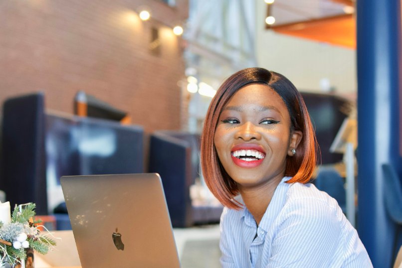 Student smiling at her laptop