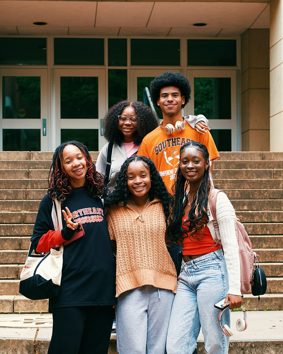 Smiling students on campus steps